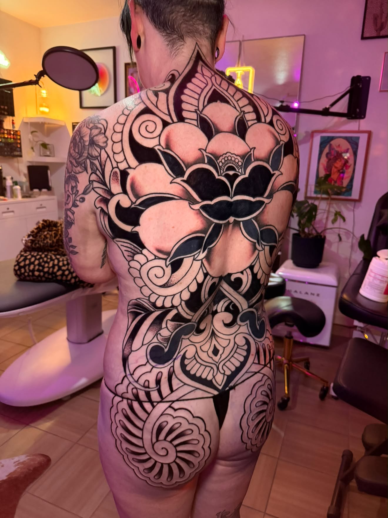 Full back and hip piece by Jenna, bold black lotus and ornament