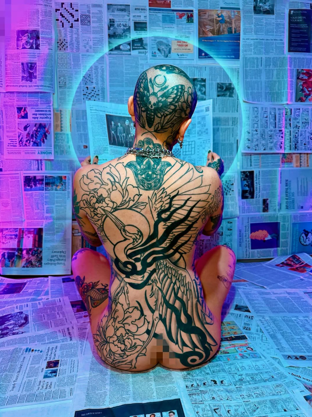 Full back piece by Jenna, ornamental linework with newspaper backdrop