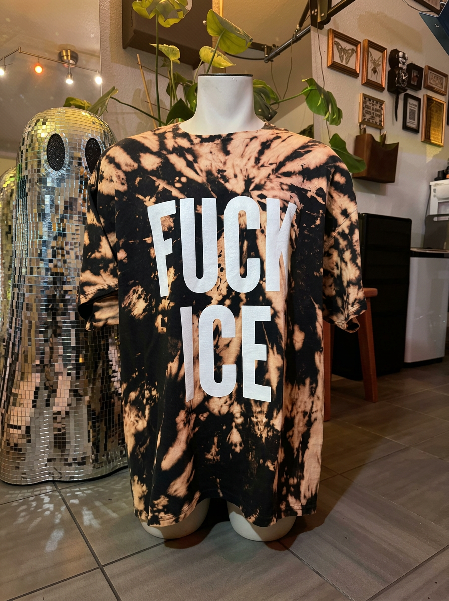 Bleach dyed brown and black tee with a white gothic FUCK ICE print, laid flat